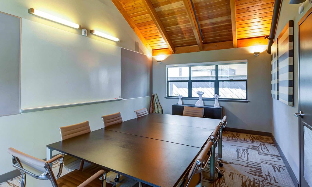 a meeting room with a long table and chairs a meeting room with a long table and chairs at The Lakes Apartments, Bellevue, 98007